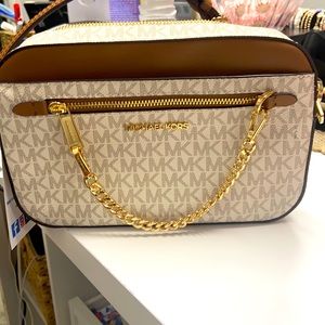 Brand new Crossbody Michael Kors logo back